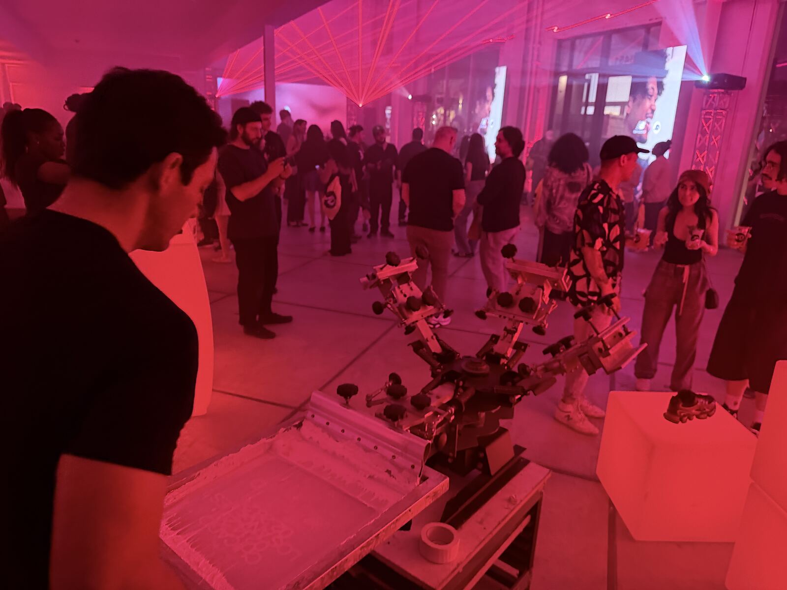 Event booth displaying custom screen-printed white t-shirts and decorated apparel samples
